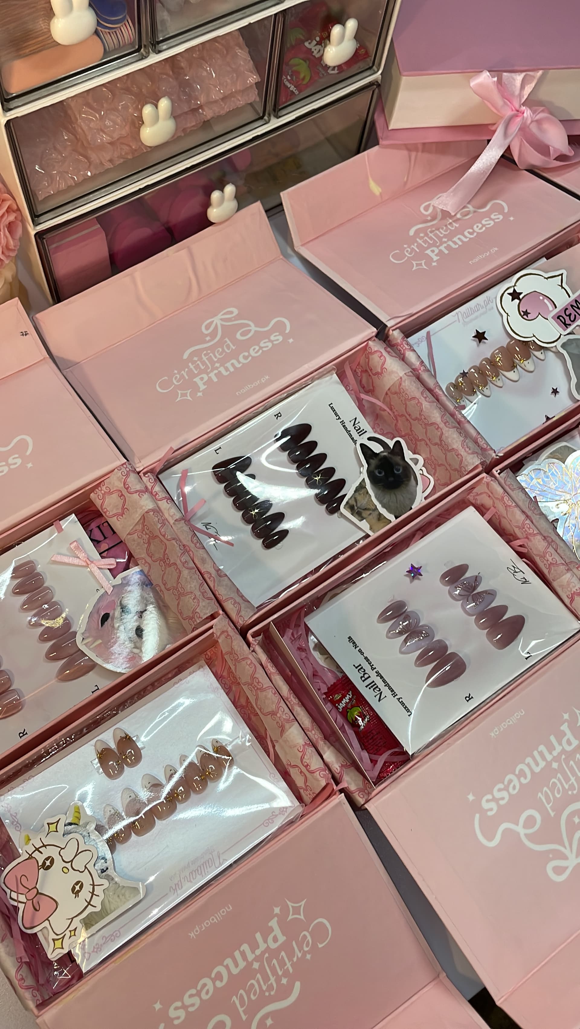 Sets sealed and ribboned inside their boxes, ready to close