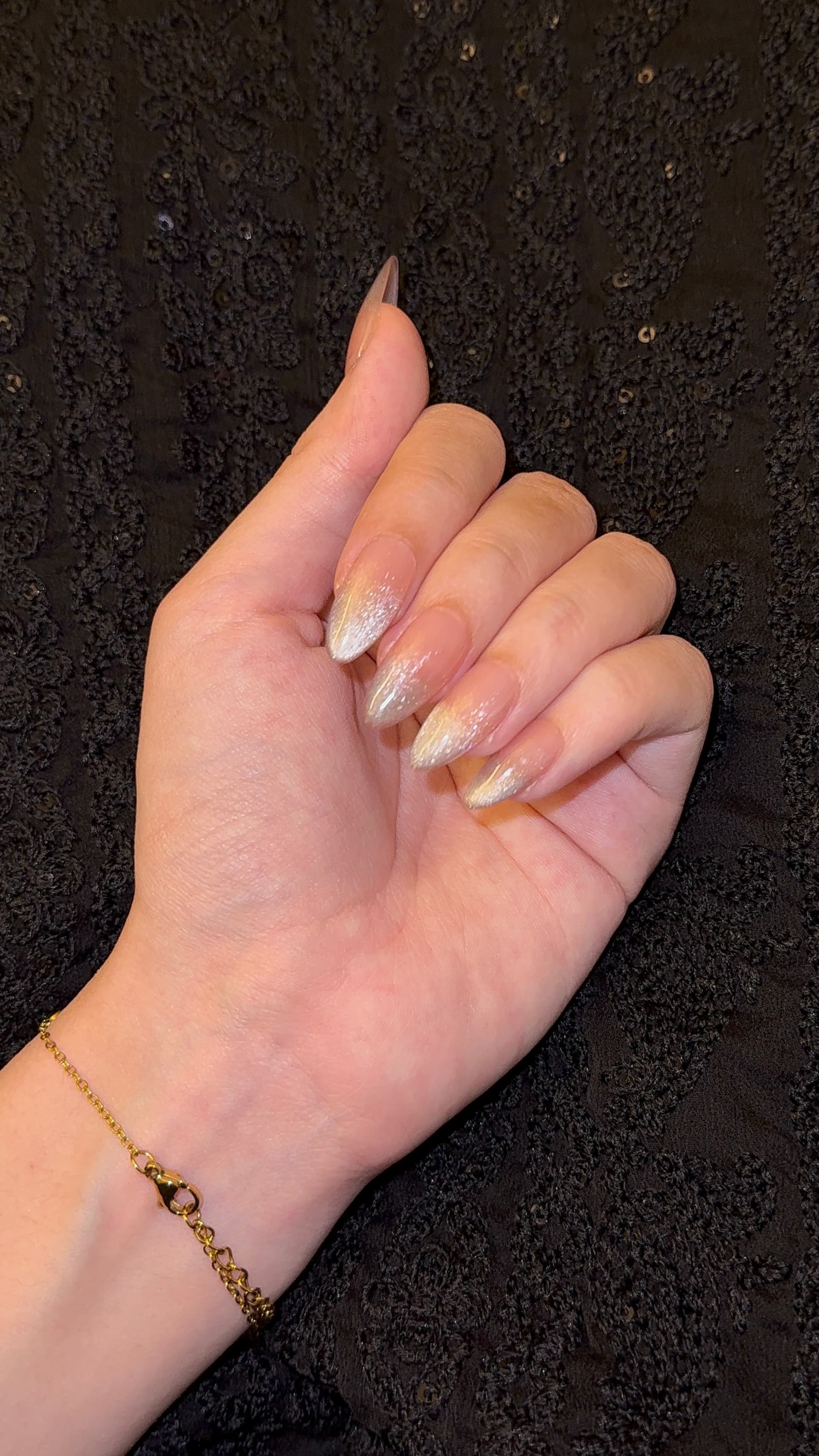 A pearl and gold glitter ombre set, worn