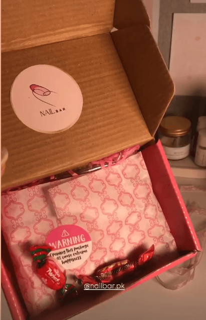 A parcel opened, with tissue and sweets inside