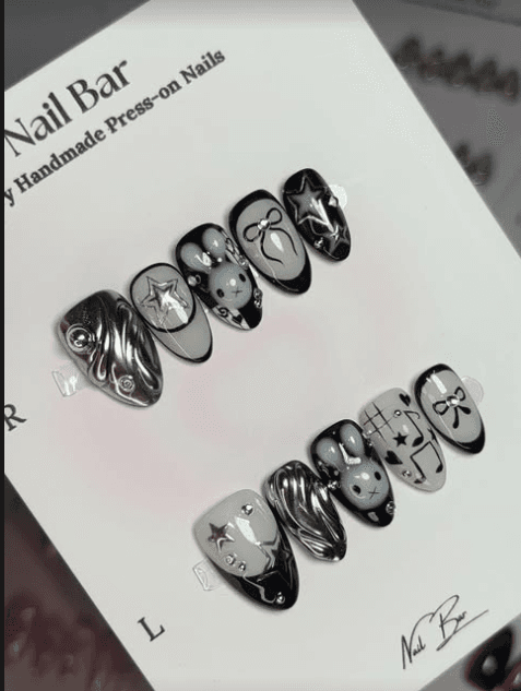A black and chrome set with stars and bows, on its card