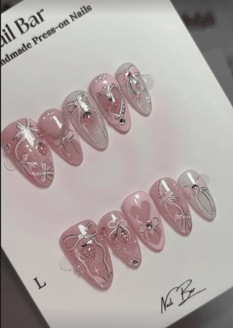A pink set with bows and strawberries, on its card